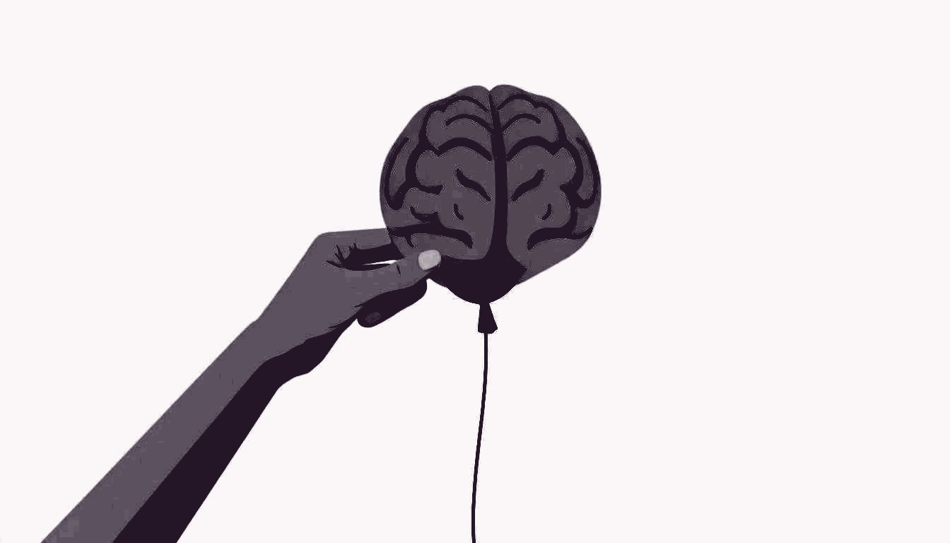 A hand gently squeezes a balloon shaped like a brain, the balloon bulging and straining.